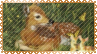 a stamp with a golden lace border. it shows a fawn lying down in a field.